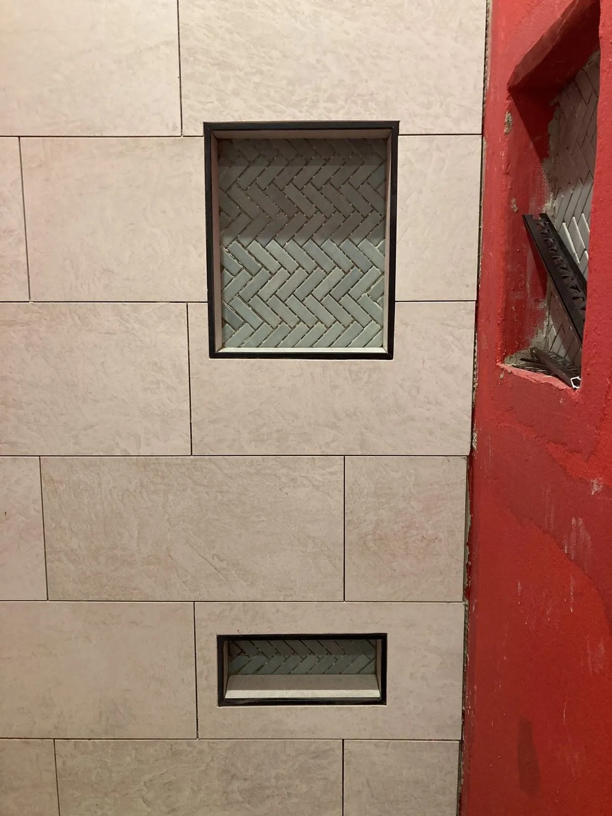 Bathroom tile work — large format tile with herringbone niche accents